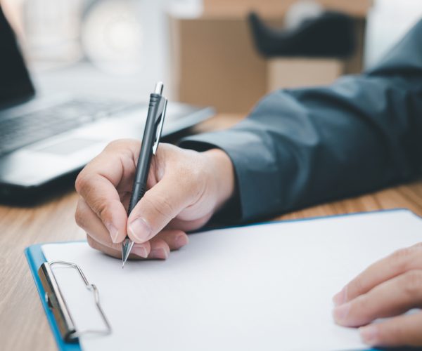 A,Man,Checking,The,Delivery,List,And,Writing,On,The